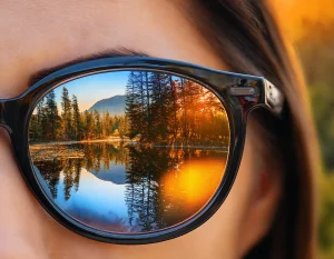 Firefly A close up of eyeglasses with clearly visible lenses reflecting vibrant outdoor scenery sym Premier Optical