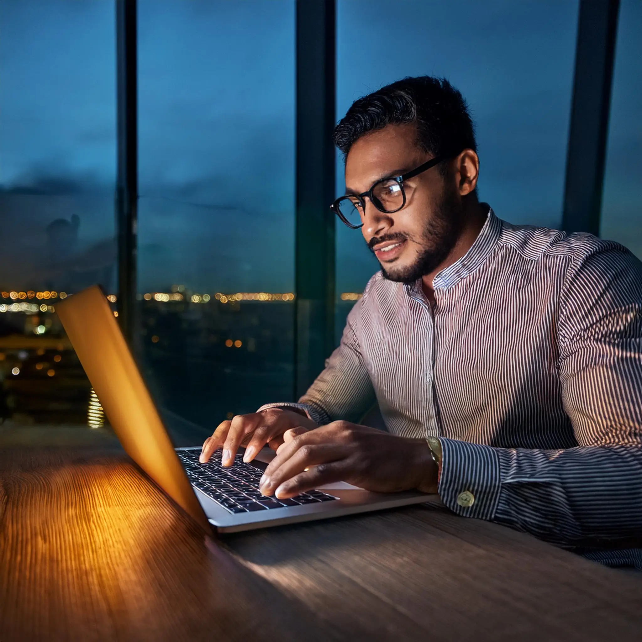 Firefly A night time scene of a person wearing computer glasses working on a laptop with a warm e Computer Glasses