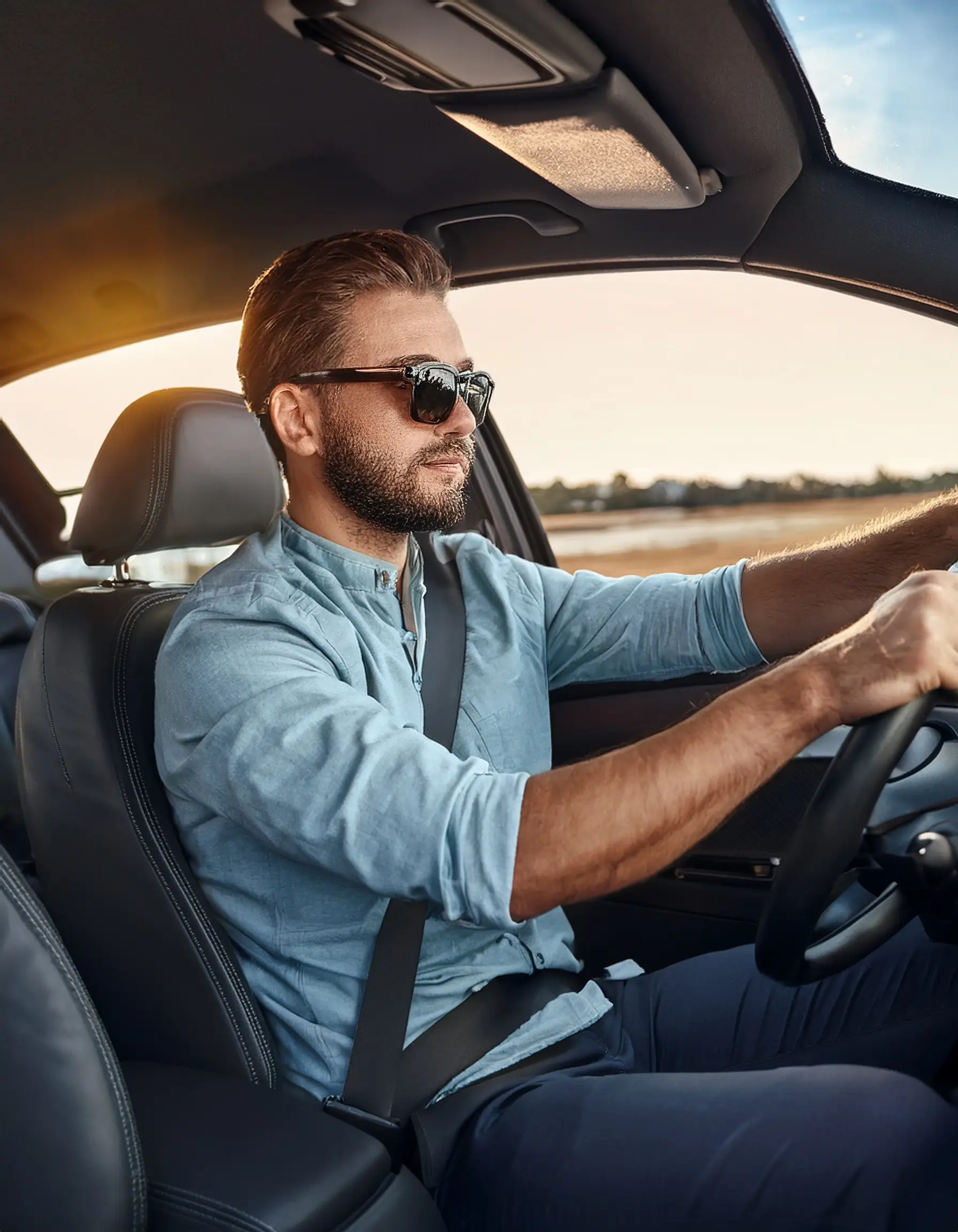 Firefly A professional driver gripping the steering wheel looking focused while wearing prescriptio Premier Prescription Sunglasses in Waterloo